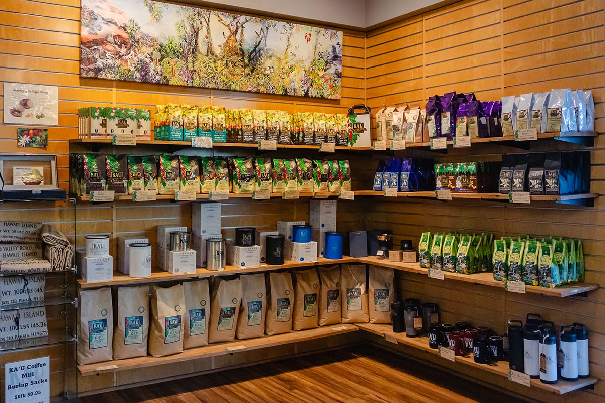 Kaʻū Coffee Roasters Cafe interior with shelves displaying various coffee products